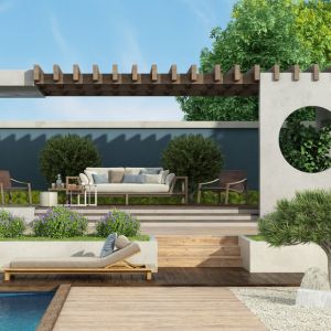 Photographie d’un jardin moderne au Pays basque avec terrasse bois, plantes locales et allée minérale, symbole d’un aménagement extérieur durable.